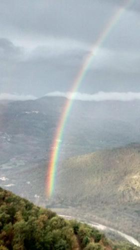 a rainbow in the sky over a field with trees at Locazione Turistica Arcobaleno "Appartamento Superior" in Roccavivara