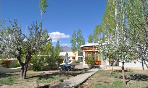 a house with a picnic table and a gazebo at Royal Heritage Resort in Leh