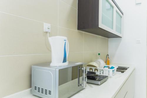 a kitchen with a white appliance on a counter at Shawn Akademic Suites Pool View @ Mount Austin in Johor Bahru