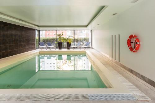 a swimming pool in the middle of a house at Skyscraper Riverview Lisbon with Indoor Pool in Lisbon