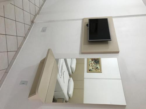 an overhead view of a white kitchen with a counter at Termas Park Hotel in Gravatal