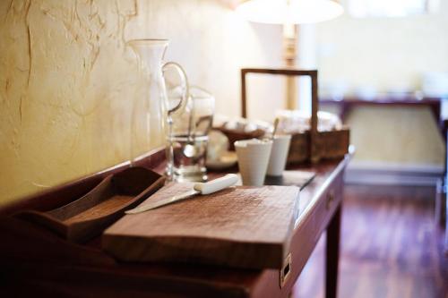 a wooden table with a glass vase on top of it at Barnabrow Country House in Killinagh