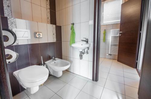 a bathroom with a toilet and a sink at WX Hotel in Bratislava