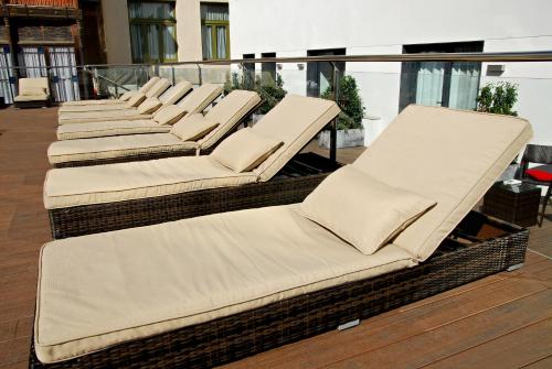 a row of chaise lounges on a balcony at Grupotel Gran Via 678 in Barcelona