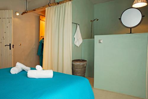 a room with a blue bed with towels on it at Villa Melani in Mytilini