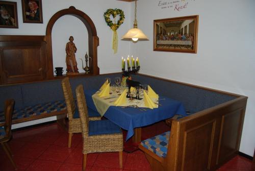 a dining room with a blue table and chairs at Hotel Garni Wolfgang in Saalbach Hinterglemm