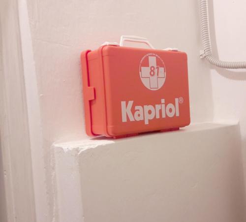 a red suitcase is sitting on a wall at Casa Zelia in Castiglioncello