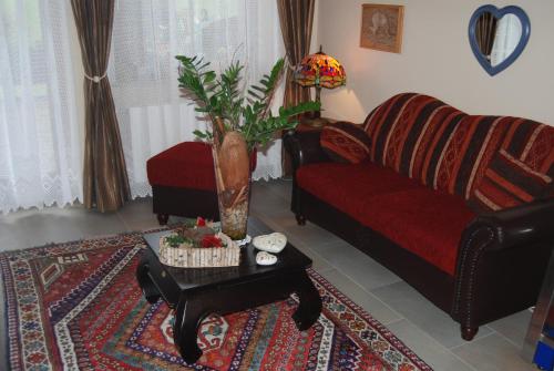 a living room with a couch and a coffee table at Hotel Garni Wolfgang in Saalbach Hinterglemm