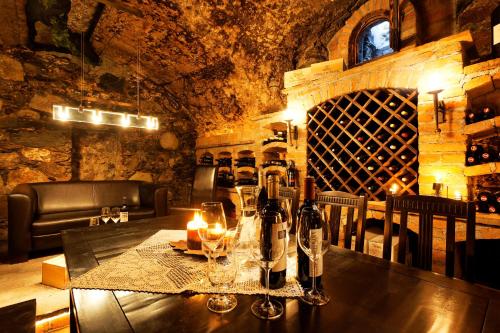 a dining room with a table with wine bottles and glasses at Hotel Flatscher in Stuhlfelden