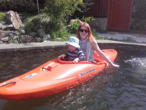 a woman and a child in an orange raft in the water at Guest House Sněžník in Sněžnik