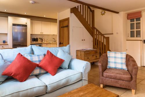 a living room with a couch and a chair at Cottage 2 New Yatt Farm in Witney