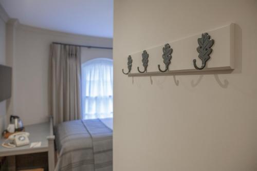 a bedroom with a bed and a room with a window at Richmond Hill Hotel in Richmond upon Thames