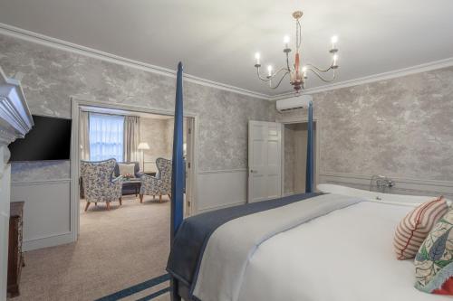 a bedroom with a bed and a table and chairs at Richmond Hill Hotel in Richmond upon Thames