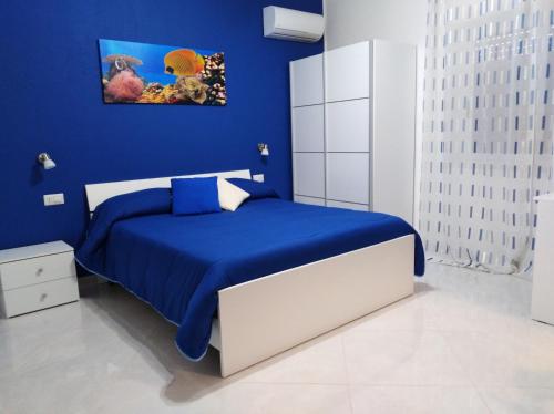 a blue bedroom with a bed with blue sheets at Villa Milena in Agropoli