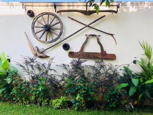 a wall with a cart on the side of a house at Forever City Hotel in Kiribathgoda