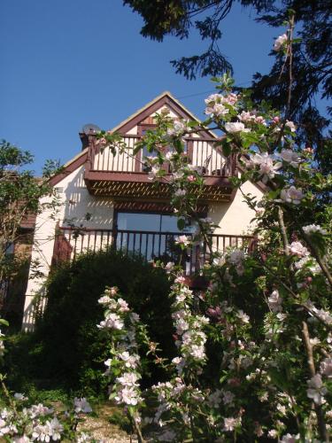 a house with a balcony and flowers in front of it at Skerries B and B in Lyme Regis