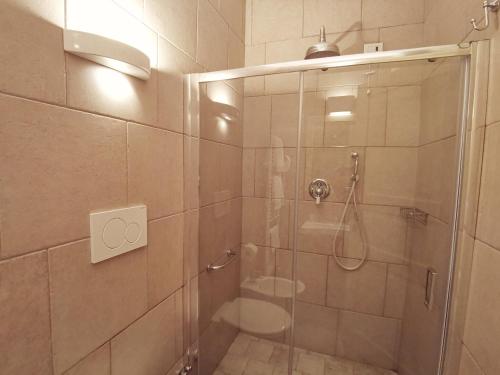 a bathroom with a glass shower with a toilet at Le Nicchie Guest House in Lucera