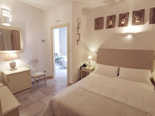a bedroom with a bed and a room with a window at Le Nicchie Guest House in Lucera