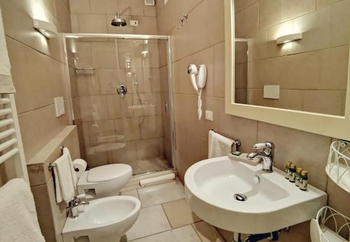 a bathroom with a sink and a toilet and a shower at Le Nicchie Guest House in Lucera