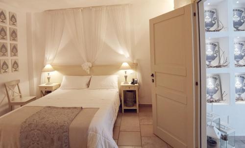 a bedroom with a white bed and two night stands at Le Nicchie Guest House in Lucera