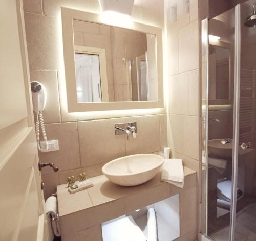 a bathroom with a sink and a mirror at Le Nicchie Guest House in Lucera