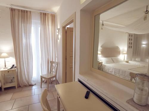 a hotel room with a bed and a mirror at Le Nicchie Guest House in Lucera