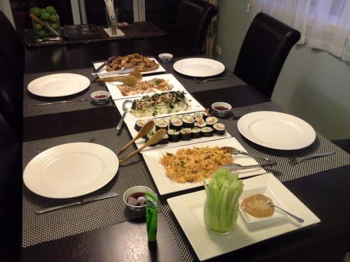 a long table with plates and food on it at 16 Havelock in New Plymouth