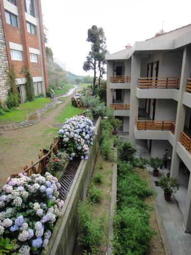 a view of a garden of flowers in a building at Club Mahindra Kanatal in Kanatal