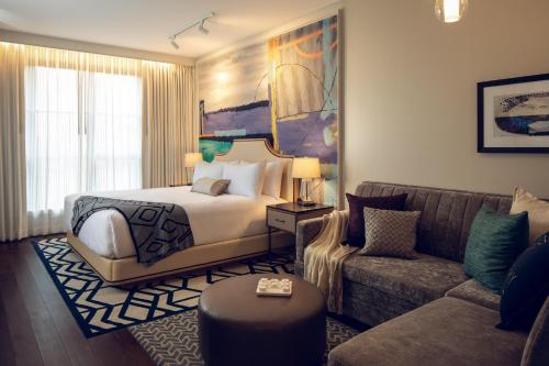 a hotel room with a bed and a couch at Sophy Hyde Park in Chicago