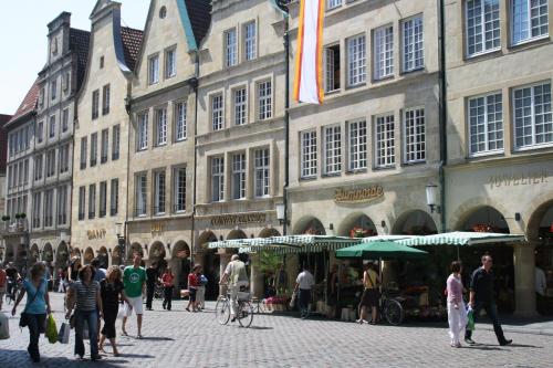 a group of people walking in front of a building at Ibis Münster City in Münster