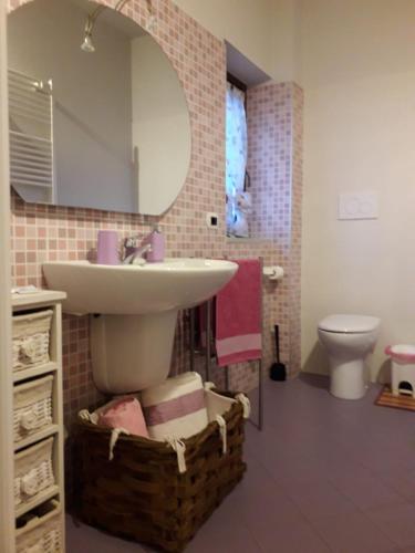 a bathroom with a sink and a toilet and a mirror at Bed and Breakfast Ca D'Pandin in Peveragno