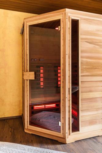 a room with a glass door in a wooden house at Haus Sieben - Singer Lydia in Kötschach
