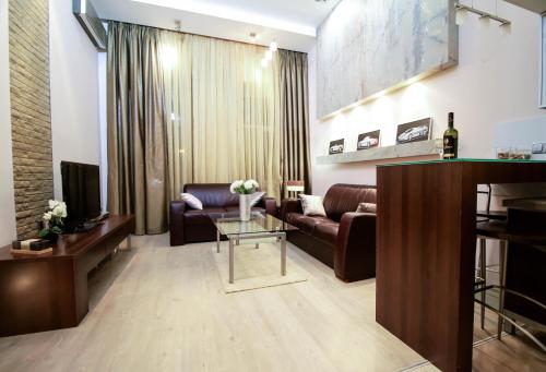 a living room with a couch and a table at Langery Residence Central Apartments in Odesa