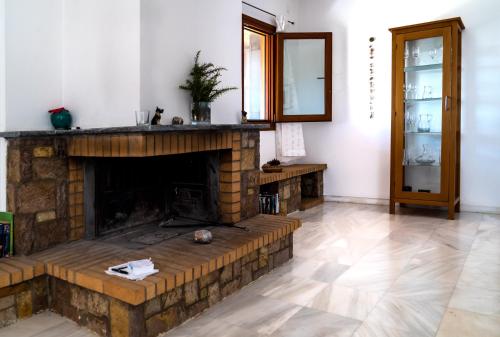 a living room with a fireplace and a mirror at Terra Ionian in Áyios Ilías