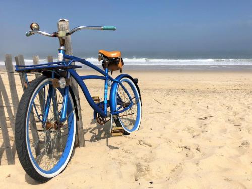 a blue bike is parked on the beach at Beach House Dewey in Dewey Beach