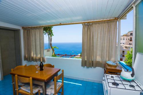a kitchen with a table and a view of the ocean at Casa Maresca Residence in Positano