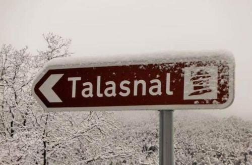 a sign that reads talasal is covered in snow at Casinha do Talasnal in Lousã