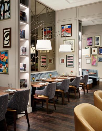 a dining room with wooden tables and chairs at Sophy Hyde Park in Chicago