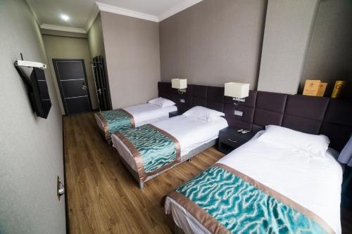 Voodi või voodid majutusasutuse Golden Hotel toas