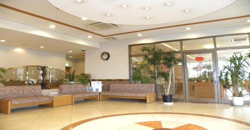 a lobby with a waiting room with couches and a clock at Hotel Benex Yonezawa / Vacation STAY 14346 in Yonezawa