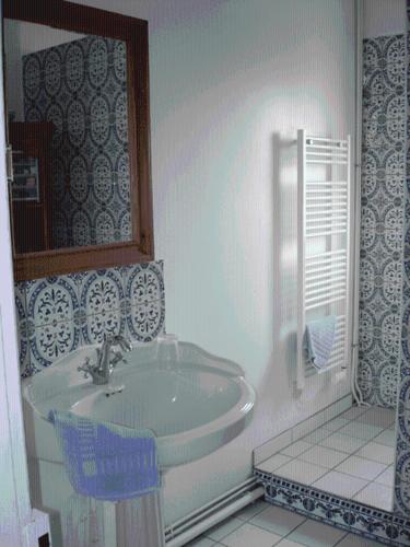 a white bathroom with a sink and a mirror at Chez Jeanne et Vittorio in Lambersart