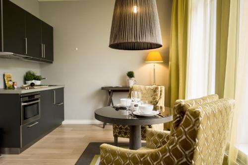 a kitchen with a table and two chairs and a table at Frogner House - Skovveien in Oslo
