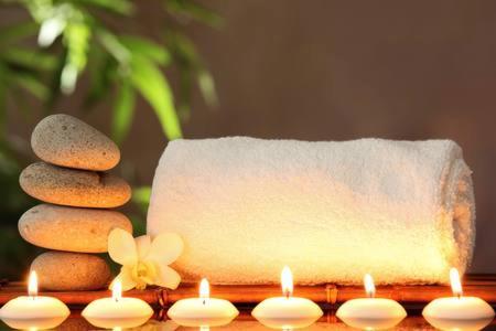 a table with candles and a stack of rocks and a piece of paper at Providence Cottage a Sussex boutique retreat for two in Angmering