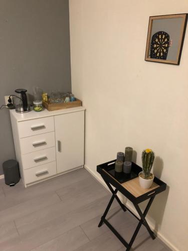 a room with a table and a dresser in a room at Chill & Party in Breda