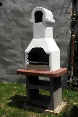 a pizza oven sitting in the grass at Arany Szőlő Wellness Apartmanház in Hévíz