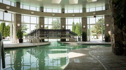 a large indoor pool in a building with windows at Grandover Resort & Spa, a Wyndham Grand Hotel in Greensboro