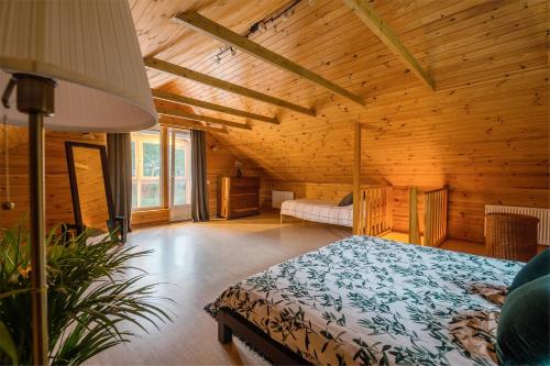 a bedroom with a bed in a wooden room at Jūras Krasti Idille in Jūrmalciems