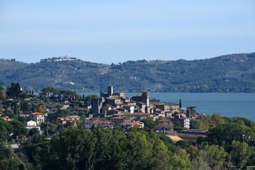 a small town on the shore of a body of water at Antico Casale Tiravento in Passignano sul Trasimeno