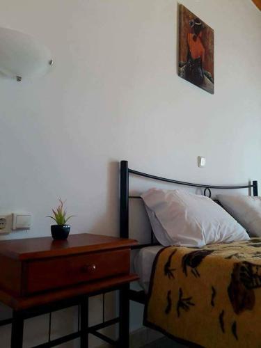 a bedroom with a bed with a nightstand next to it at Villa Thanos in Marathias