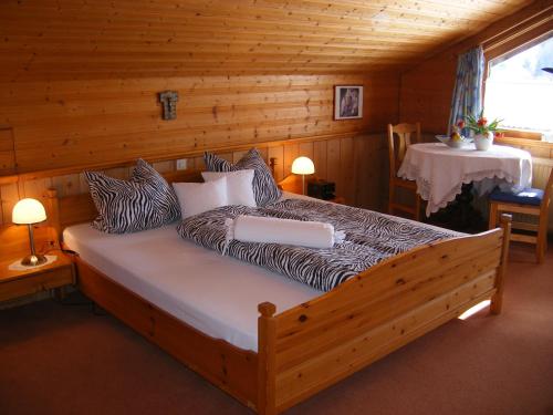 a bedroom with a bed in a log cabin at Ferienwohnungen Frick in Möggers